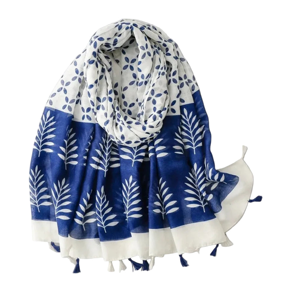Blue and white patterned scarf with tassels on a light gray background