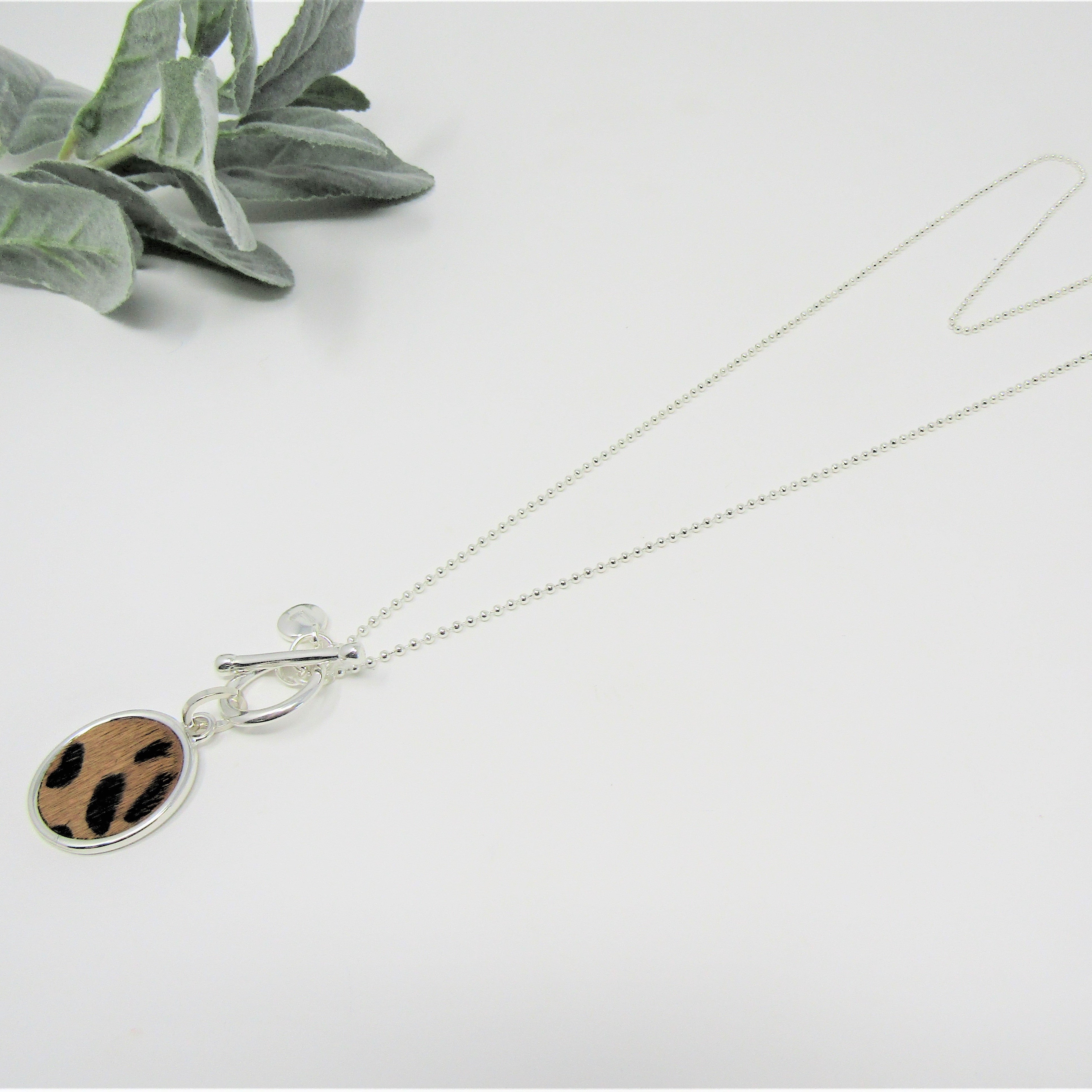 lillyco ladies long necklace with brown and black leopard print disc.