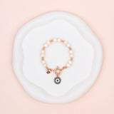 Rose Gold Eye Pendant on Freshwater Pearl Bracelet