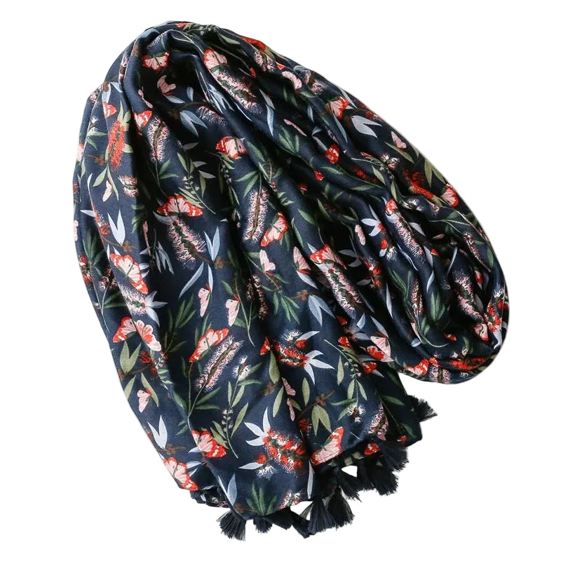 Floral patterned scarf on a white surface with a magazine underneath
