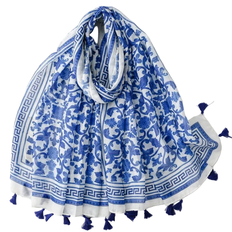 Blue and white patterned scarf with tassels on a white background