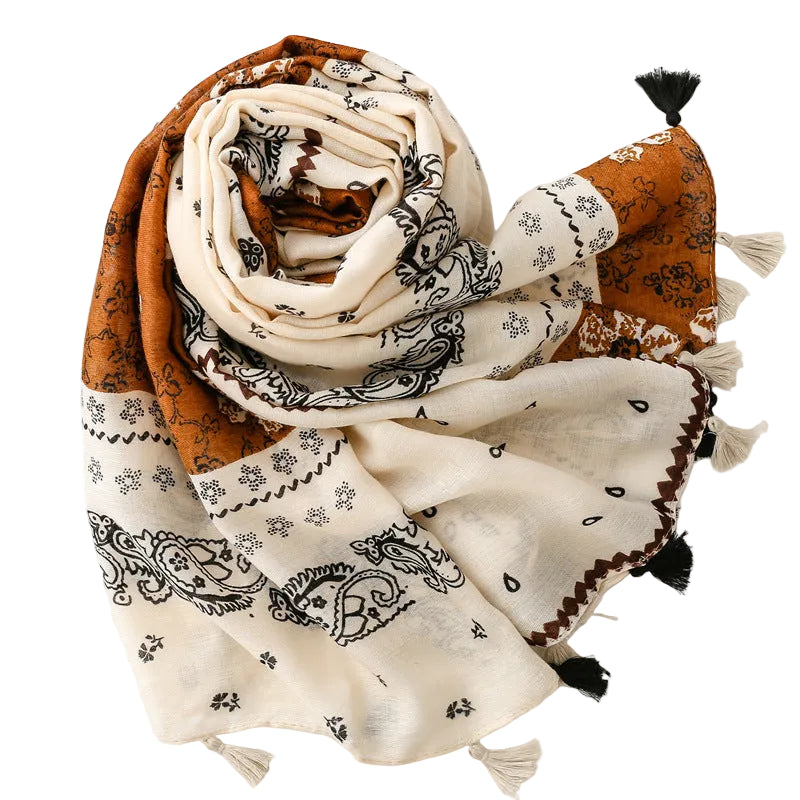 White and orange scarf with black patterns and tassels on a white background